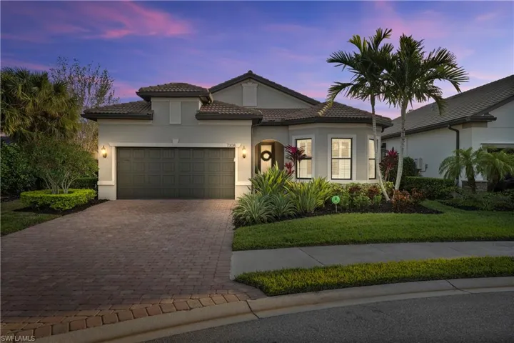 Mediterranean / spanish-style house featuring a yard and a garage