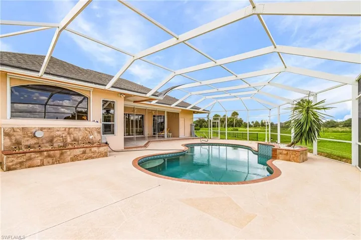 Outdoor pool featuring a patio area and glass enclosure