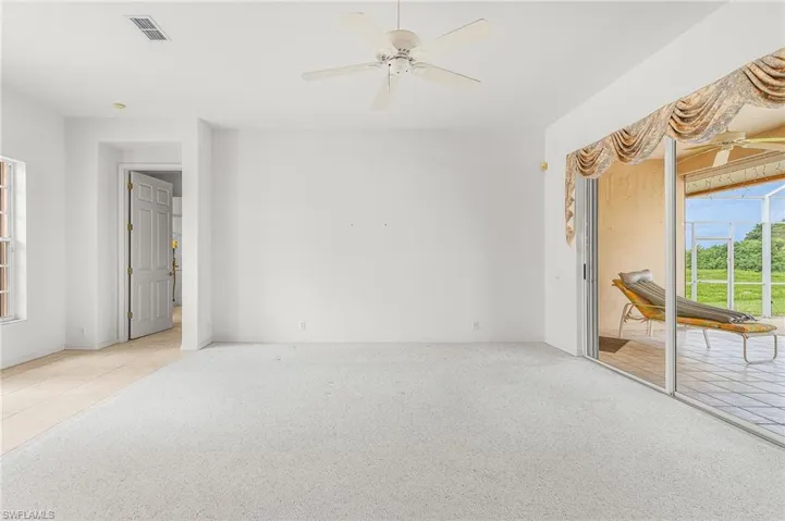 Spare room with carpet and a ceiling fan