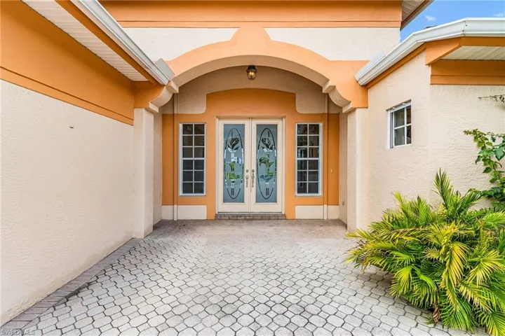 Doorway to property with stucco siding and french doors