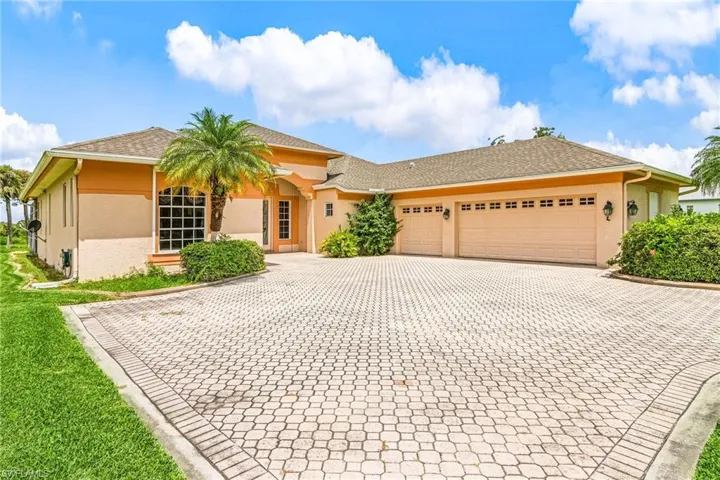 View of front of house featuring stucco siding, decorative driveway, a shingled roof, and an attached garage