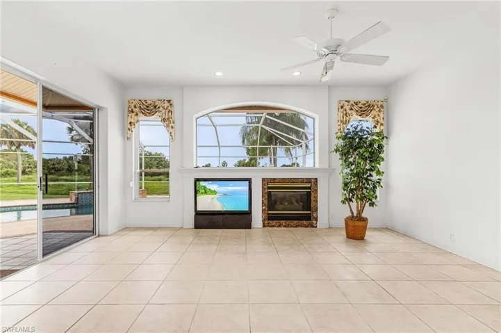 Unfurnished living room with a high end fireplace, recessed lighting, a ceiling fan, and tile patterned floors