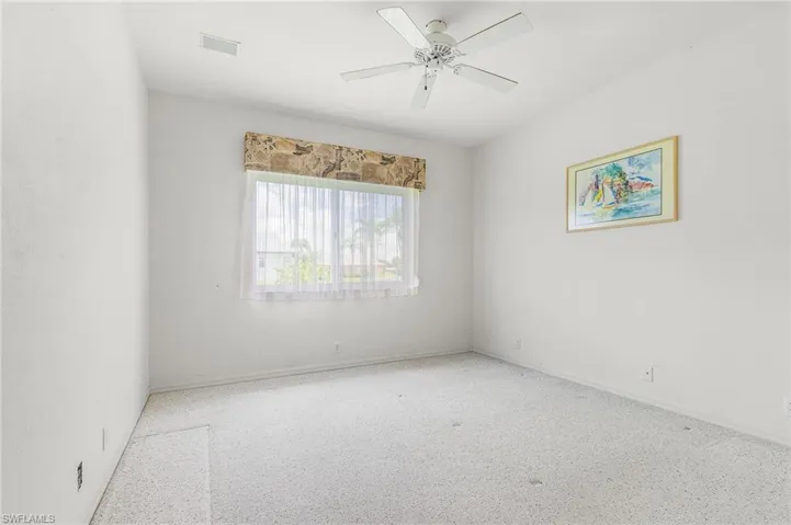 Unfurnished room with baseboards and a ceiling fan