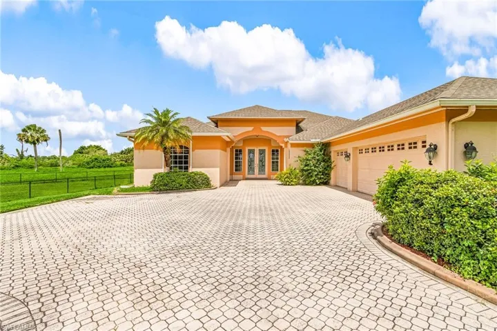 Mediterranean / spanish home with decorative driveway, french doors, stucco siding, a garage, and a shingled roof