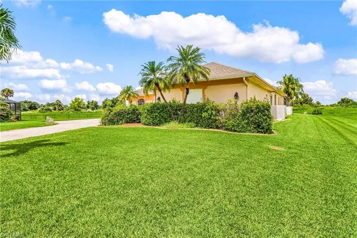 View of home's exterior featuring stucco siding and a yard