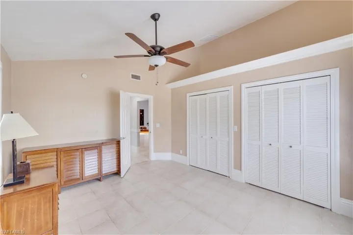 Bedroom #2 featuring high vaulted ceiling, multiple closets, and ceiling fan