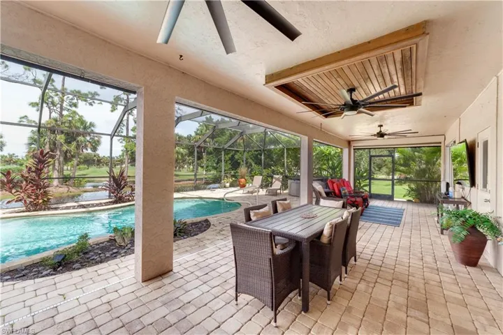 View of patio featuring a lanai and ceiling fan