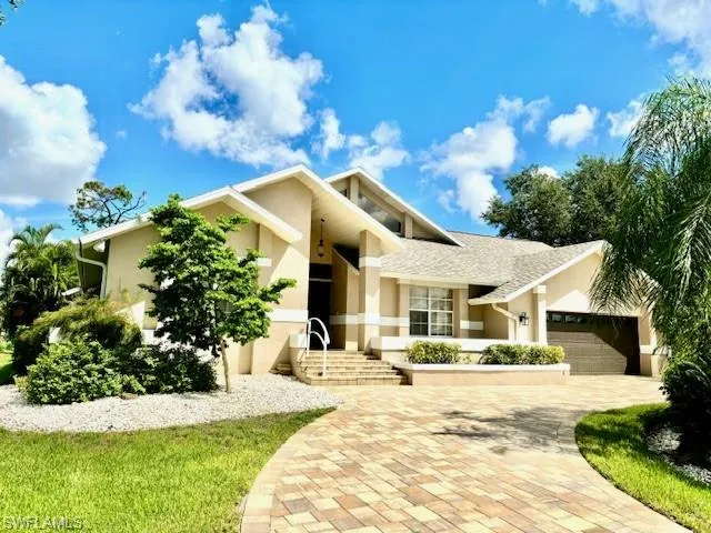 View of front facade featuring a garage