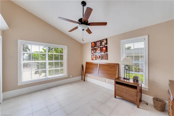 Guest Bedroom  #2  with ceiling fan, light tile patterned flooring, lofted ceiling, and a wealth of natural light