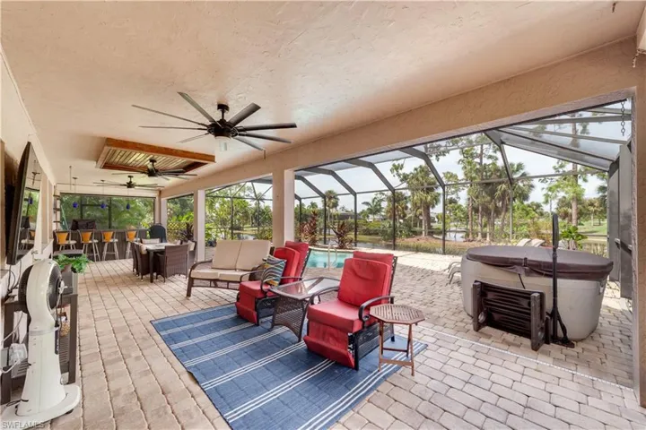 View of patio with a pool, a lanai, ceiling fan, and an outdoor hangout area