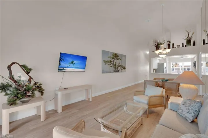 Living room featuring wood finished floors and a towering ceiling