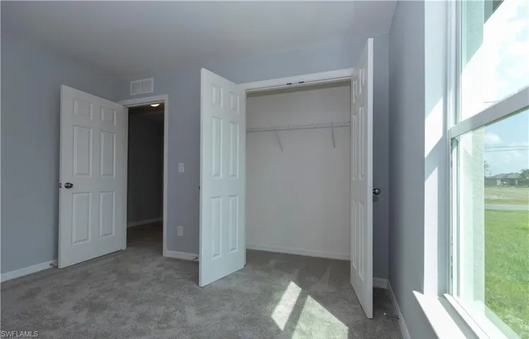 Unfurnished bedroom featuring carpet and a closet