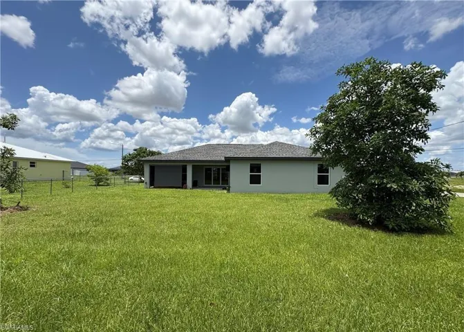 Back of property featuring stucco siding and a patio