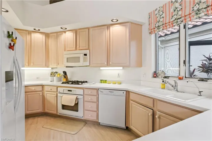 You will LOVE this beautiful kitchen with white appliances and plenty of storage space.