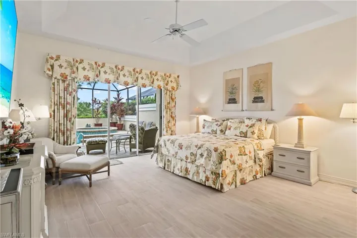 HUGE primary bedroom also offers a lovely pool view!