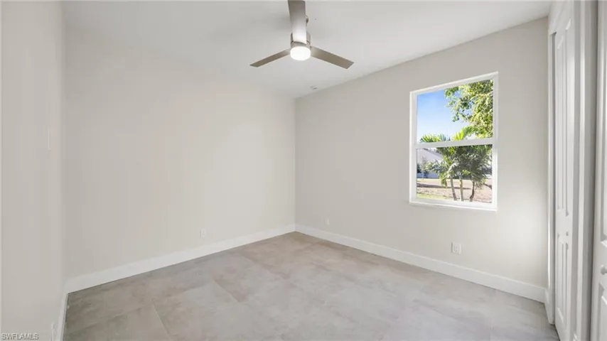 Spare room featuring baseboards and a ceiling fan