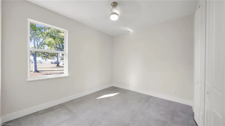 Empty room featuring baseboards