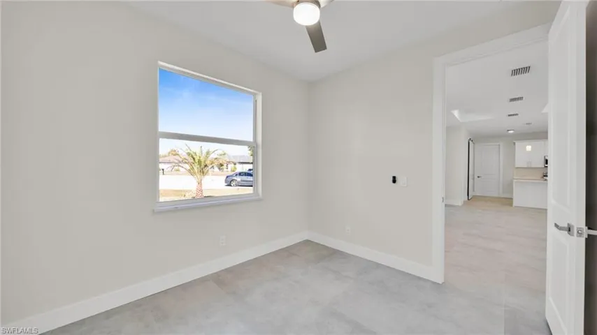 Empty room featuring baseboards and ceiling fan
