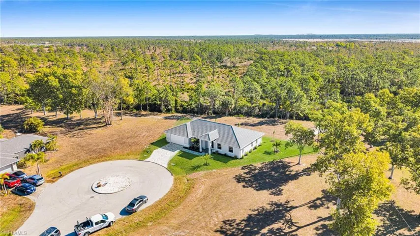 View of subject property with a forest