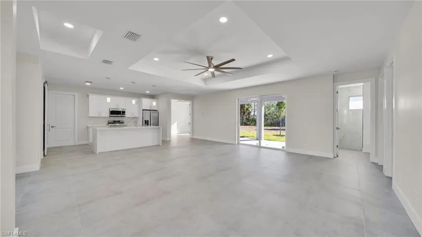 Unfurnished living room featuring recessed lighting and a ceiling fan