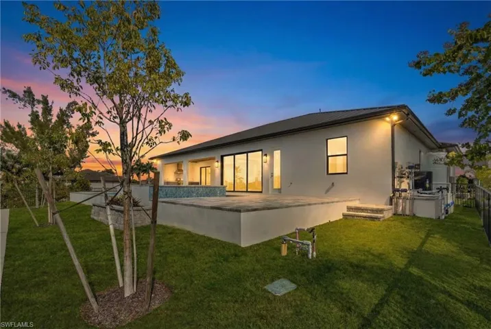 Back of property featuring a patio area and stucco siding
