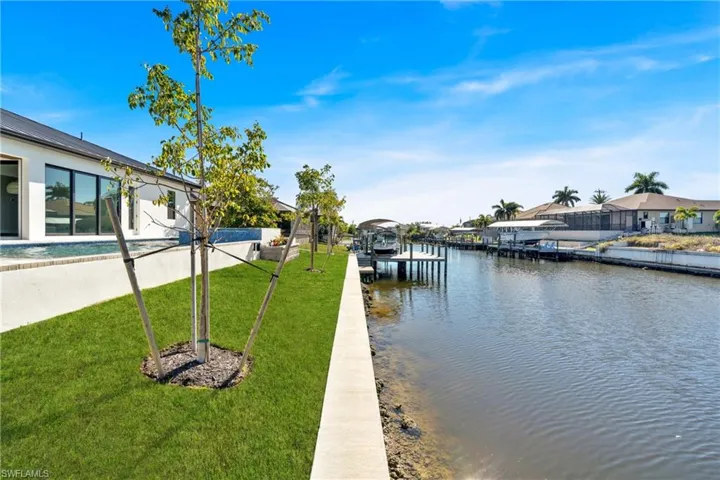 Dock with a yard, a water view, and a residential view