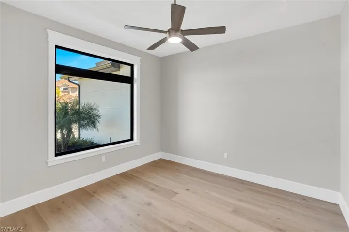 Empty room featuring light wood-style flooring and ceiling fan