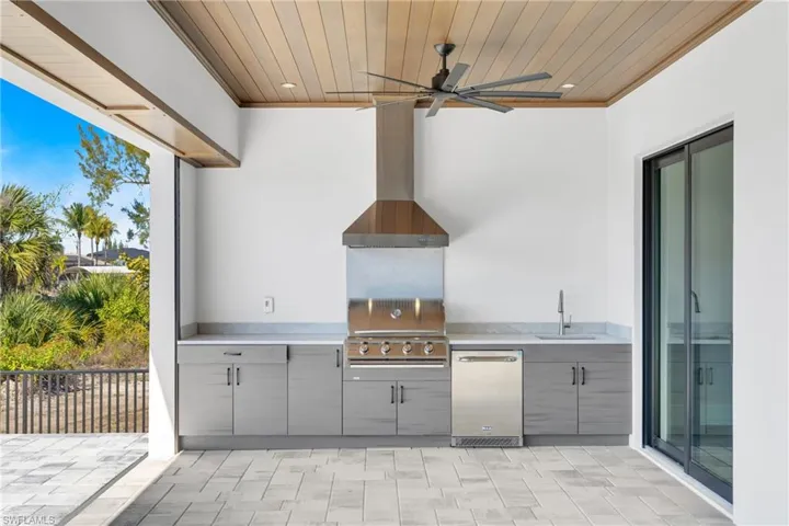View of patio with an outdoor kitchen and ceiling fan