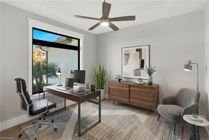 Office featuring wood finished floors, a ceiling fan, and a wall mounted air conditioner