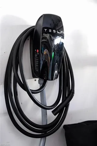 Dedicated electric vehicle charging station with integrated cable management