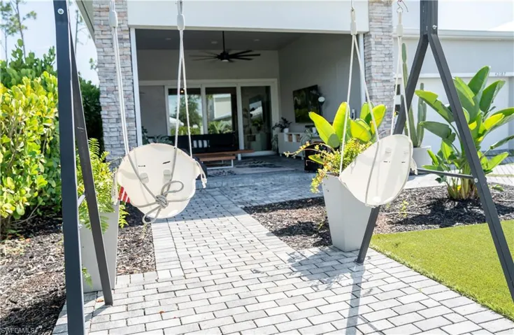 Outdoor entertainment area with paver pathway and artificial turf