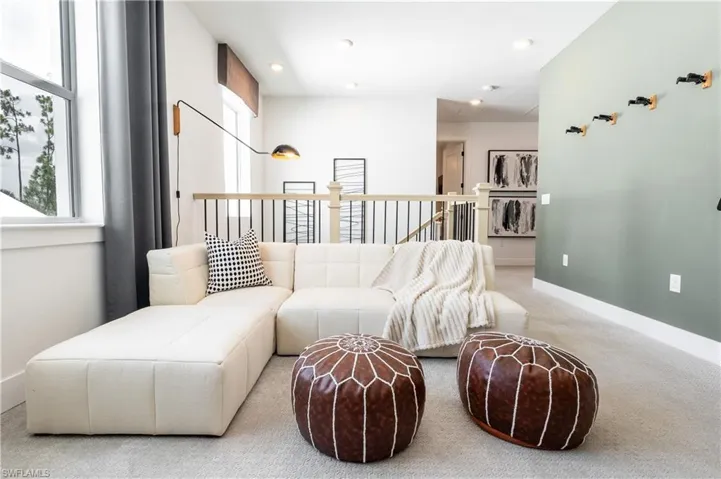 Open loft area with light-colored carpeting