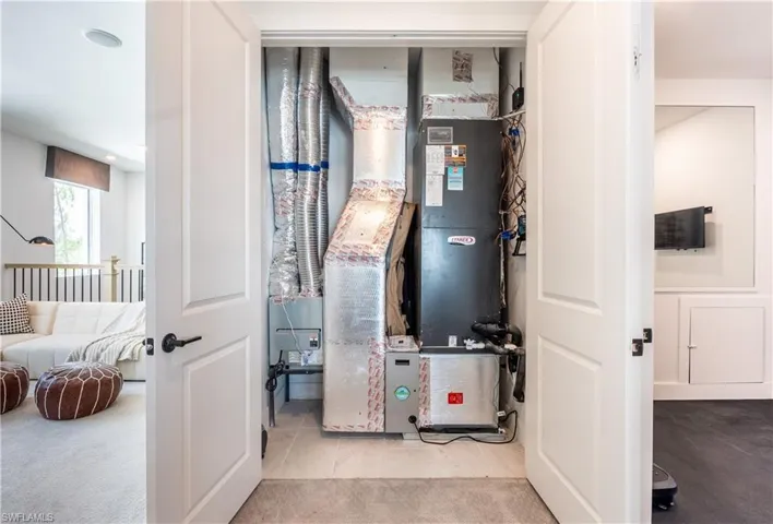 Utility closet featuring a Lennox furnace and extensive ductwork