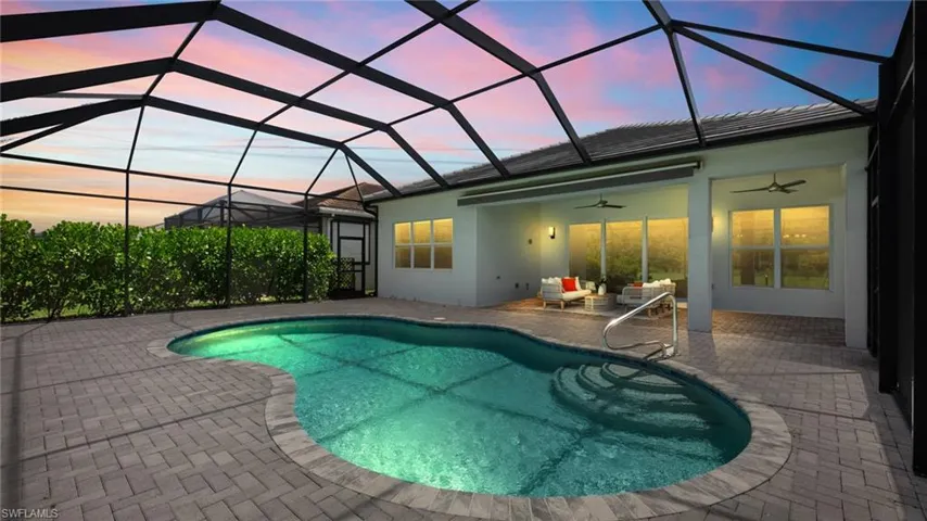 Virtually enhanced pool at dusk featuring a patio, enclosure, and ceiling fan