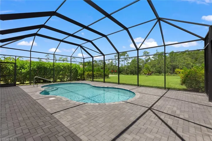 View of pool featuring a patio, a lanai, and a lawn