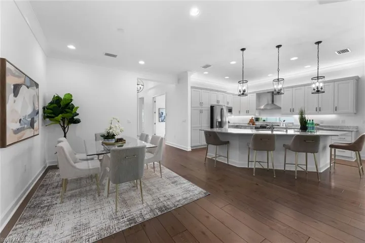 Dining room with crown molding and dark hardwood floors