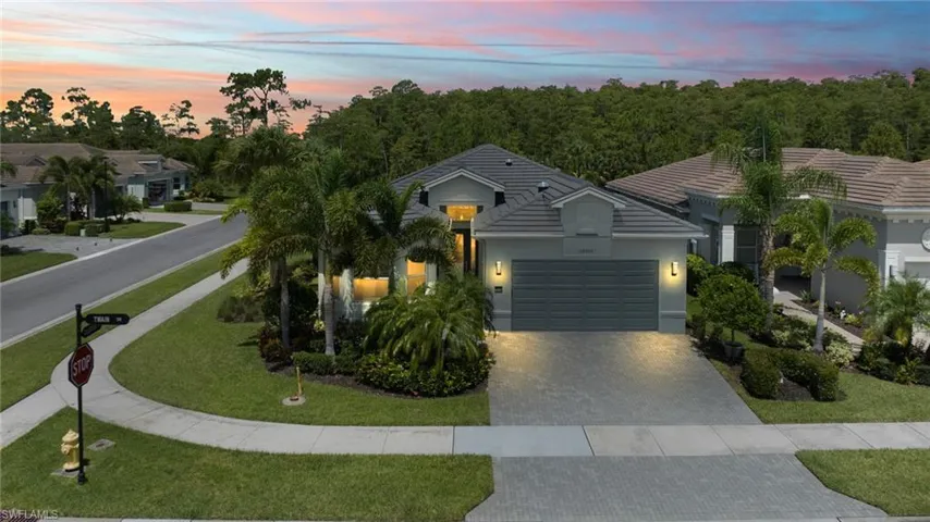 View of front of house with a garage and a lawn