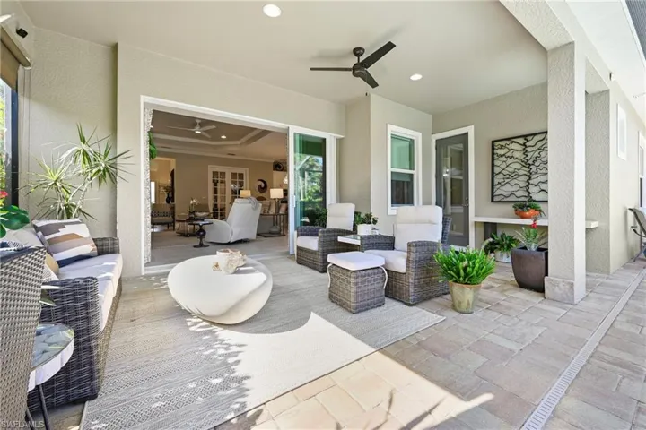 View of patio featuring an outdoor living space, ceiling fan, and french doors