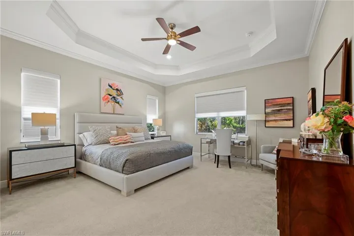 Bedroom featuring crown molding, carpet flooring, and a ceiling fan