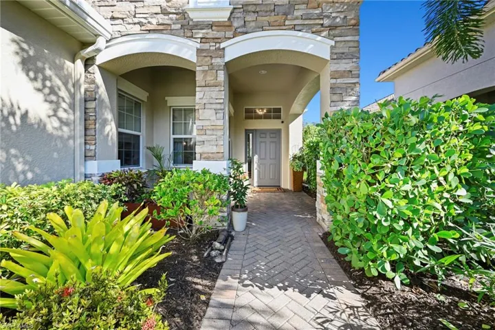 Property entrance featuring stone siding and stucco siding