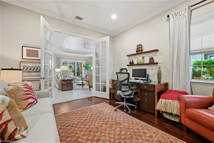 Office area featuring french doors, dark wood-style floors, ornamental molding, recessed lighting, and a tray ceiling