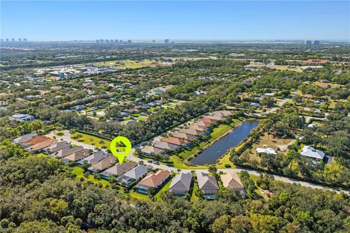 Aerial overview of property's location featuring a nearby body of water and nearby suburban area