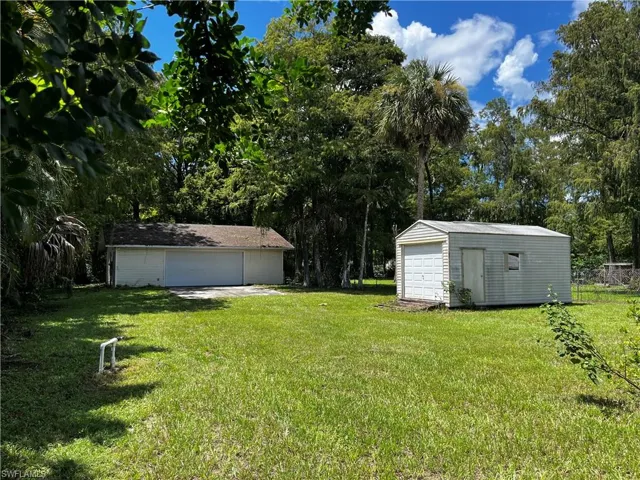 View of backyard with outbuildings