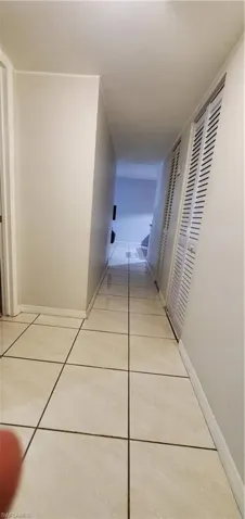 Hallway with light tile patterned flooring