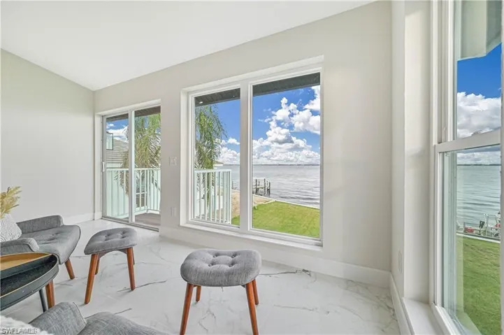 Sunroom / solarium with a water view and vaulted ceiling