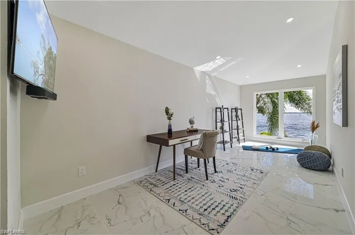Home office featuring marble tiled flooring and recessed lighting