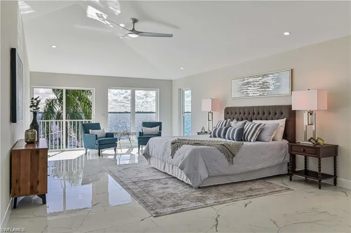 Bedroom featuring light marble finish flooring, vaulted ceiling, recessed lighting, and ceiling fan