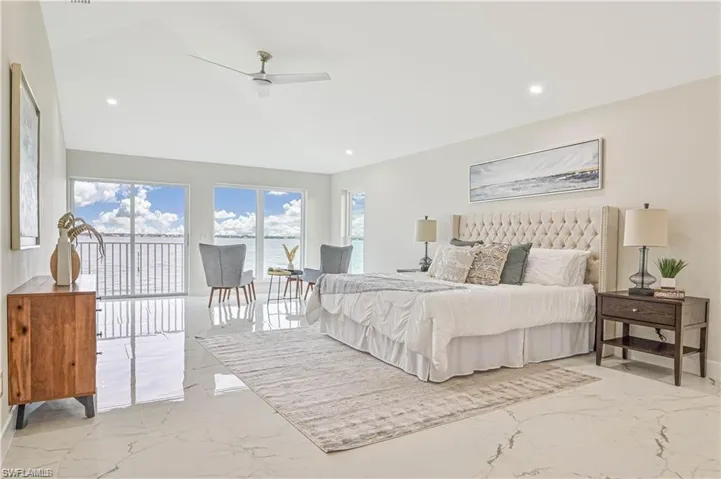 Bedroom featuring marble tiled flooring, access to outside, vaulted ceiling, a ceiling fan, and recessed lighting