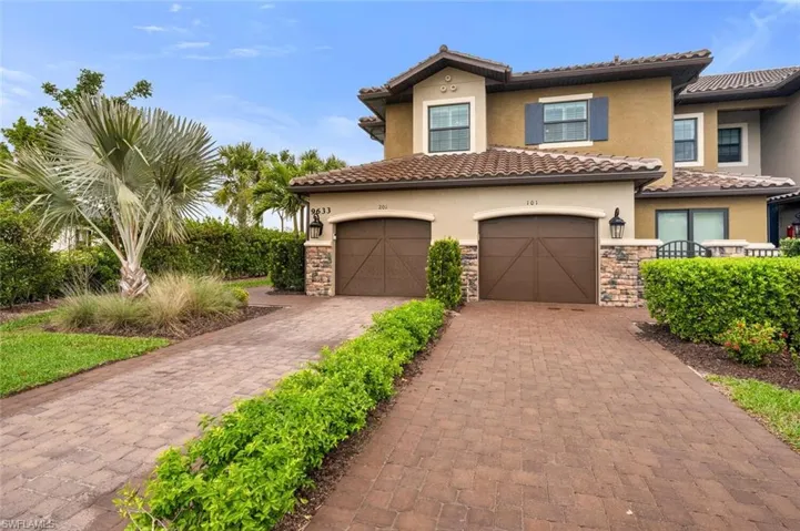 Mediterranean / spanish home with stone siding, stucco siding, a tiled roof, and decorative driveway