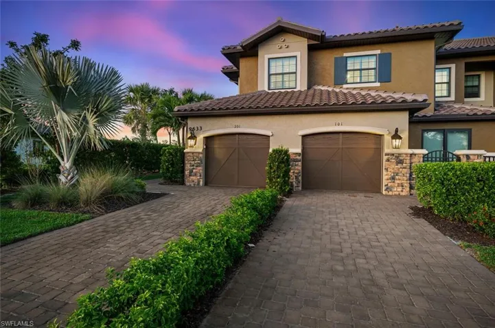 Mediterranean / spanish home featuring decorative driveway, stone siding, an attached garage, and stucco siding